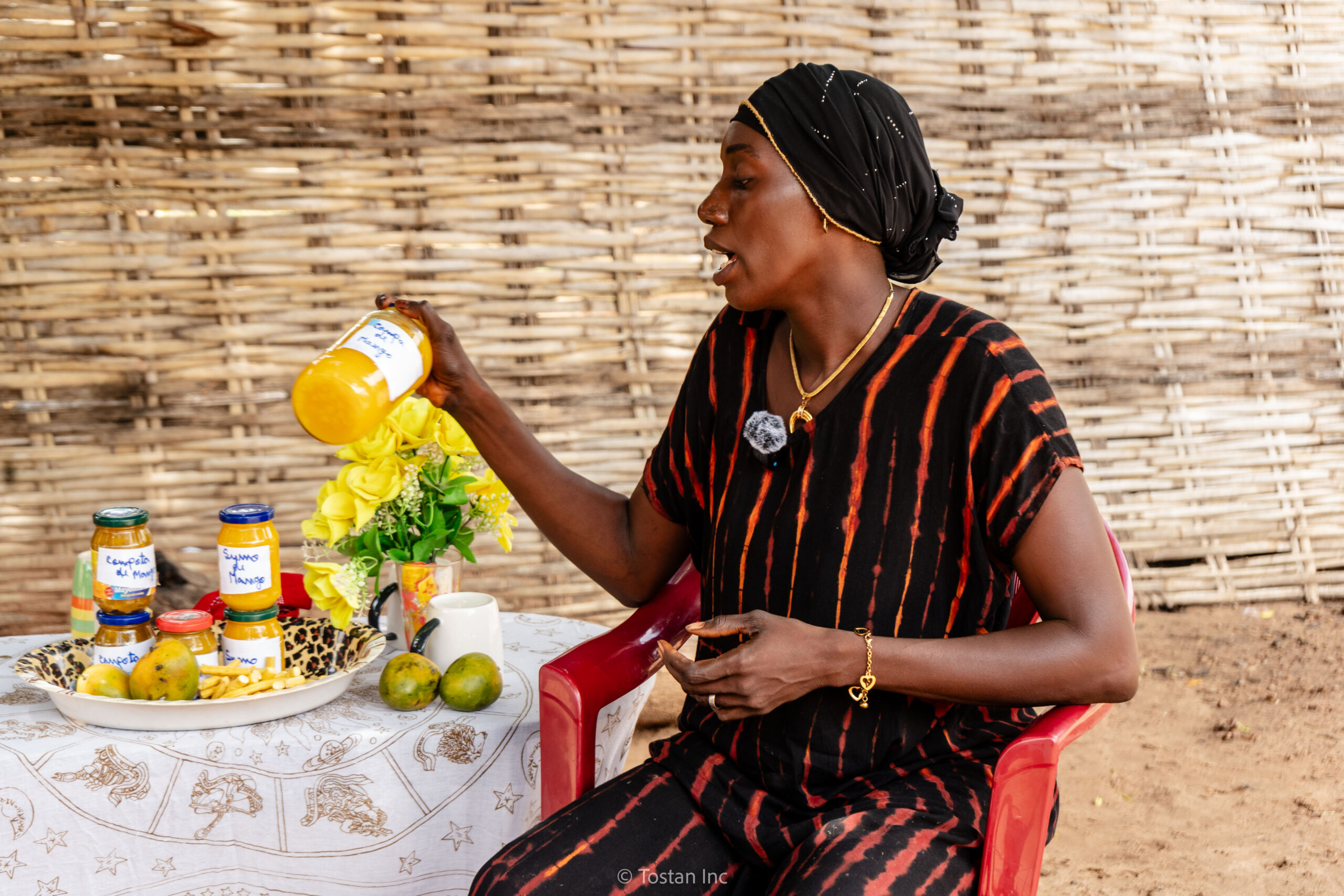 Woman with her mason jar business Tostan